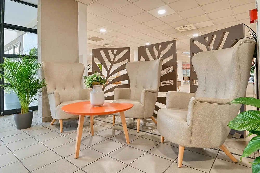 Zone de repos et détente beige avec table orange ehpad à Marseille, Résidence Marseillane
