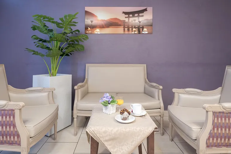 espace détente cozy avec mur violet, tableau et fauteuil confortable à Colombes