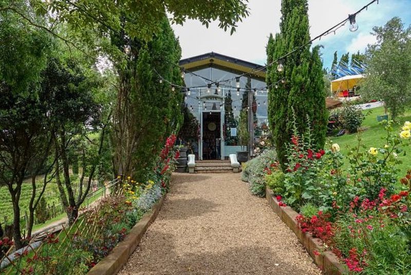 Gravel path leading to a glass restaurant