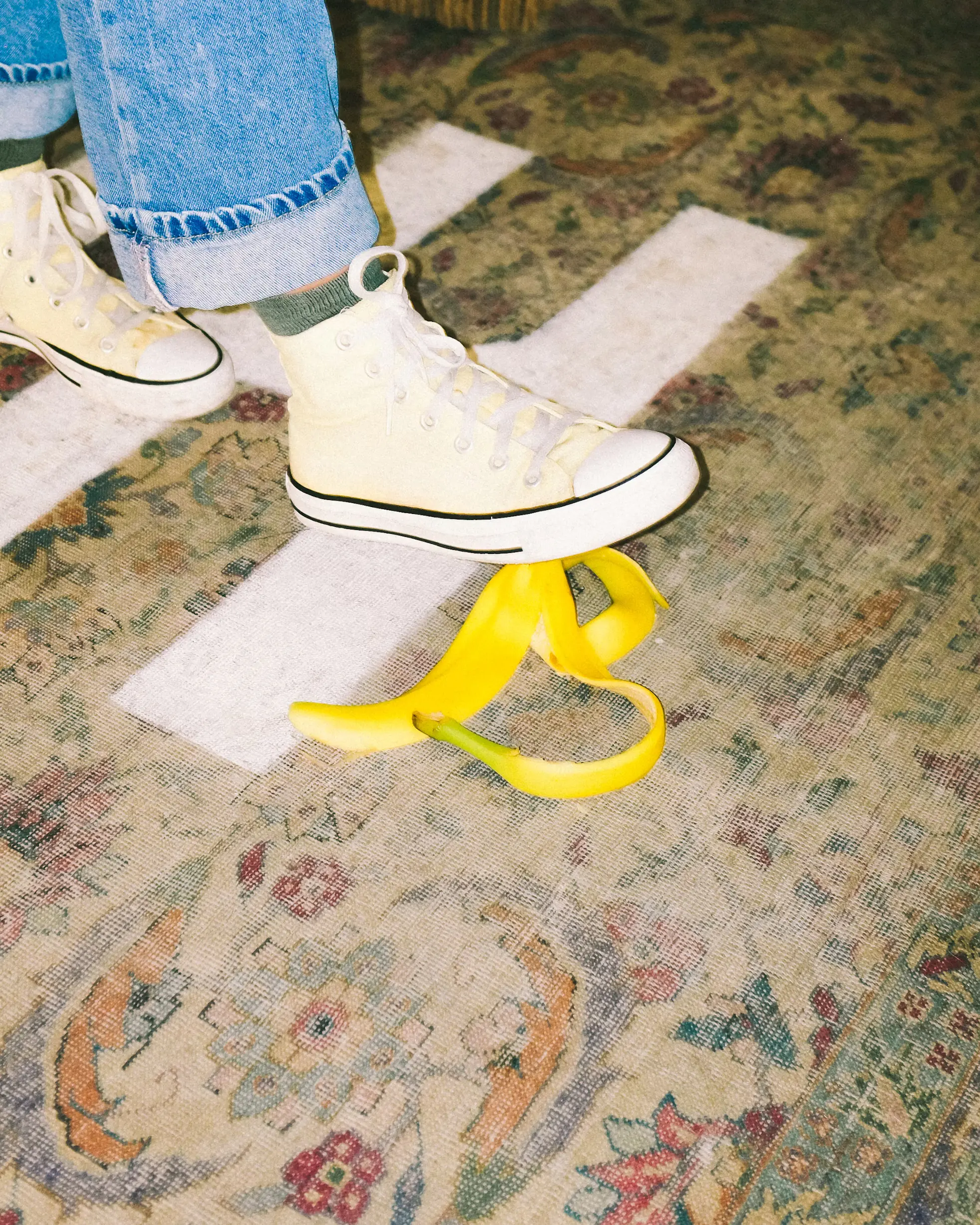 A person steeping on a banana