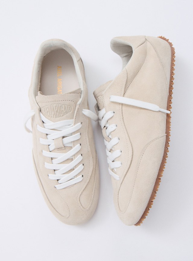 Pair of beige suede sneakers with white laces and brown rubber soles, shown from above on a white background.