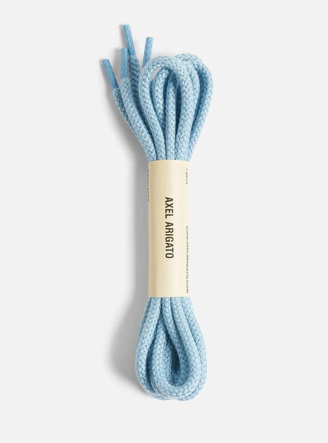 Coiled light blue shoelaces with a beige label reading "Axel Arigato" on a white background.