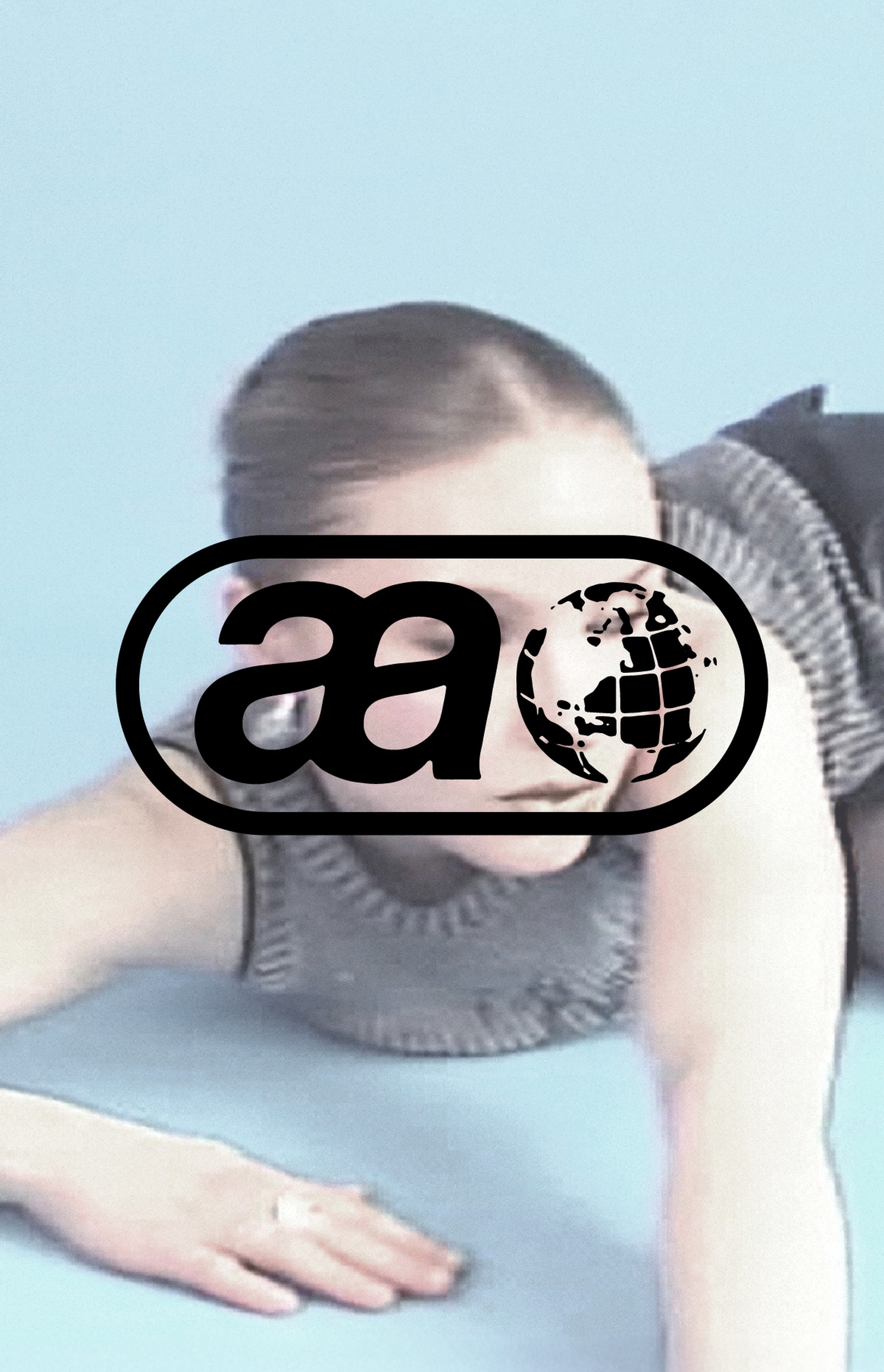 Person lying on a blue surface, partially obscured by a logo featuring stylized letters and a globe.