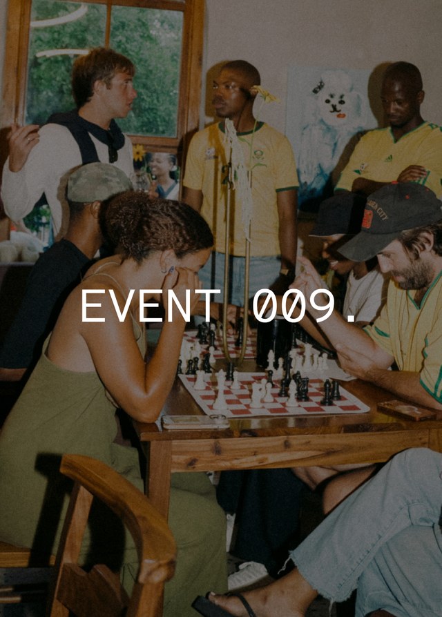 People playing chess in a lively room, with some standing around watching. Text reads "EVENT 009."