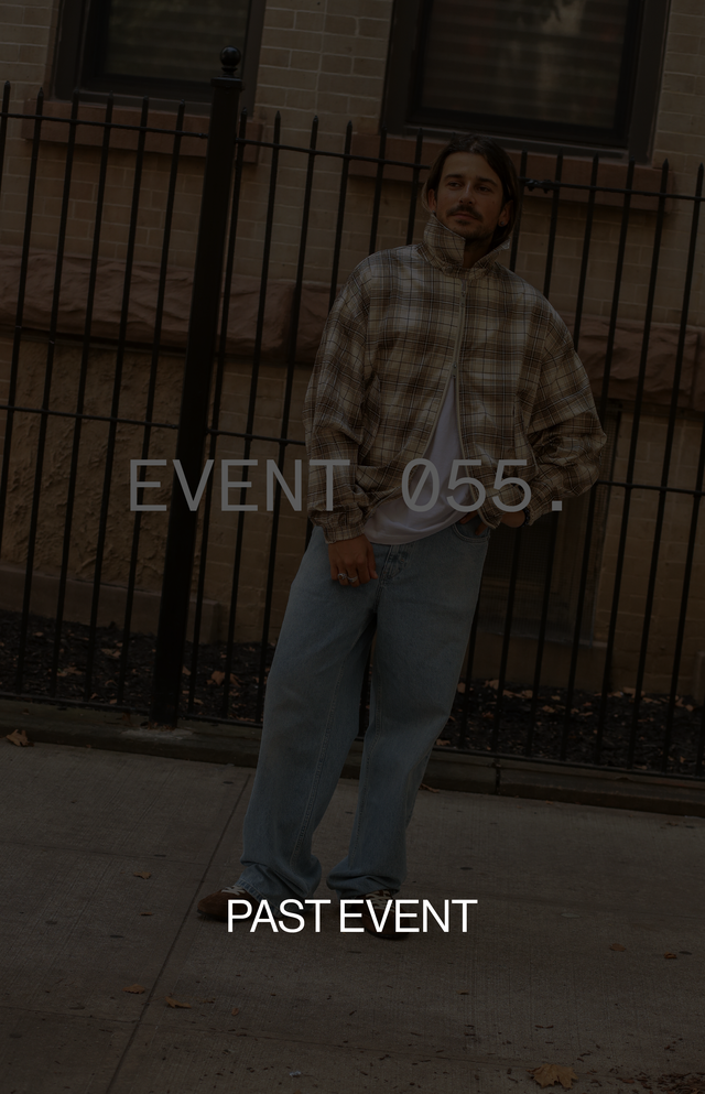A person in a plaid jacket and jeans stands on a sidewalk, leaning against a fence. Text reads "EVENT 055" and "PAST EVENT."