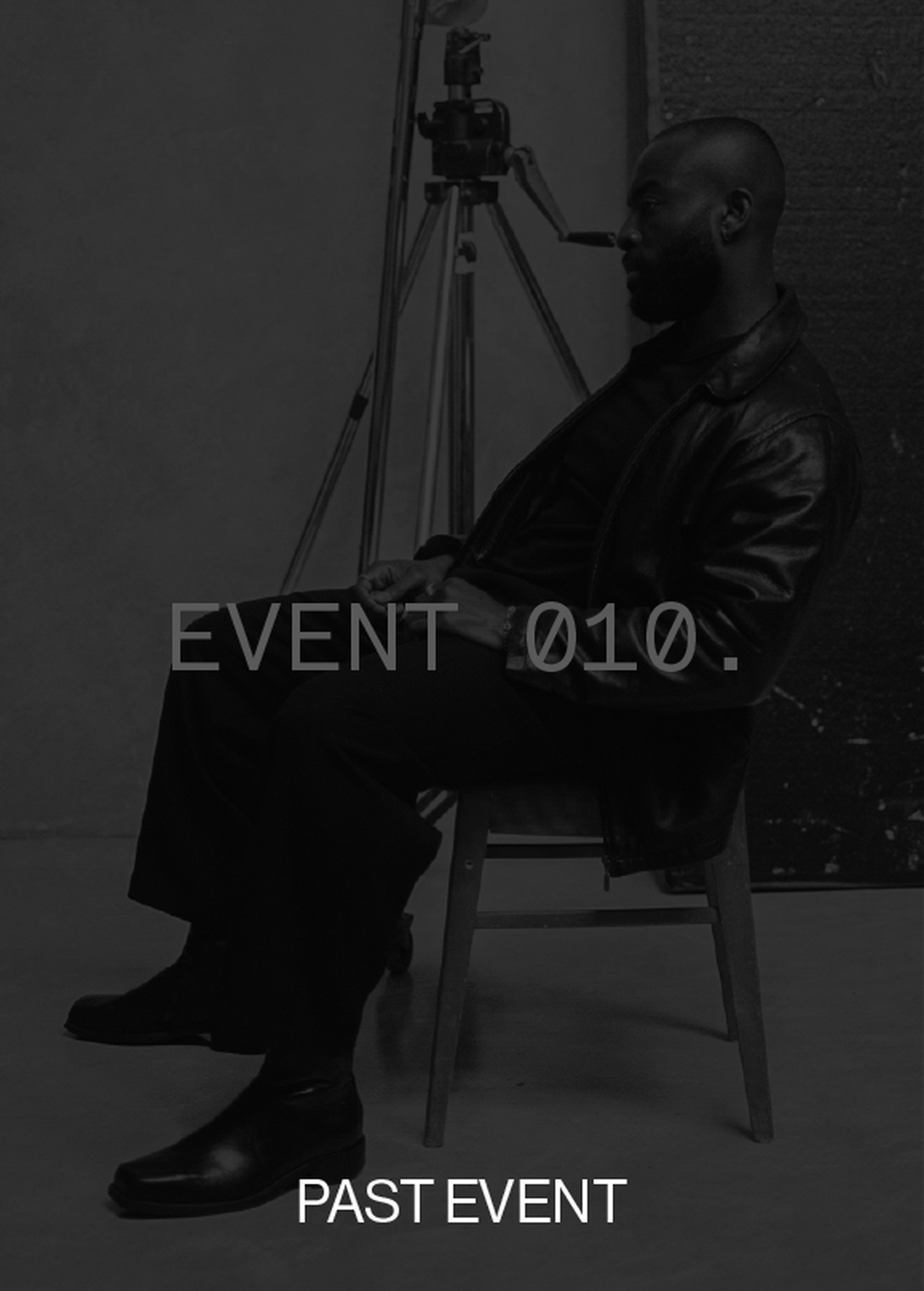 A person in dark attire sits on a chair with a tripod in the background. Overlay text reads "EVENT 010" and "PAST EVENT."
