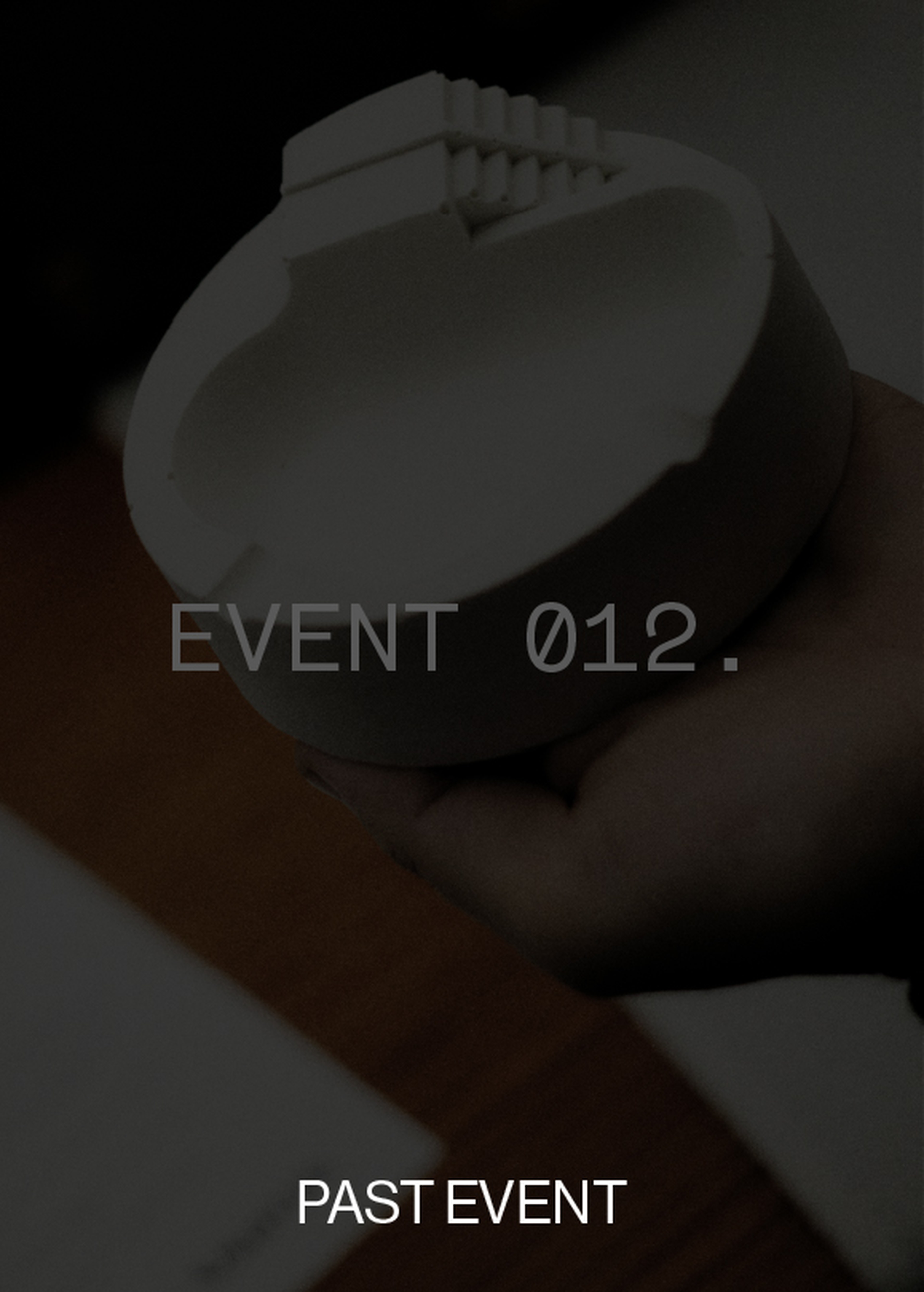 Hand holding a round, white, textured object against a dark background. Overlay text reads "EVENT 012" and "PAST EVENT."