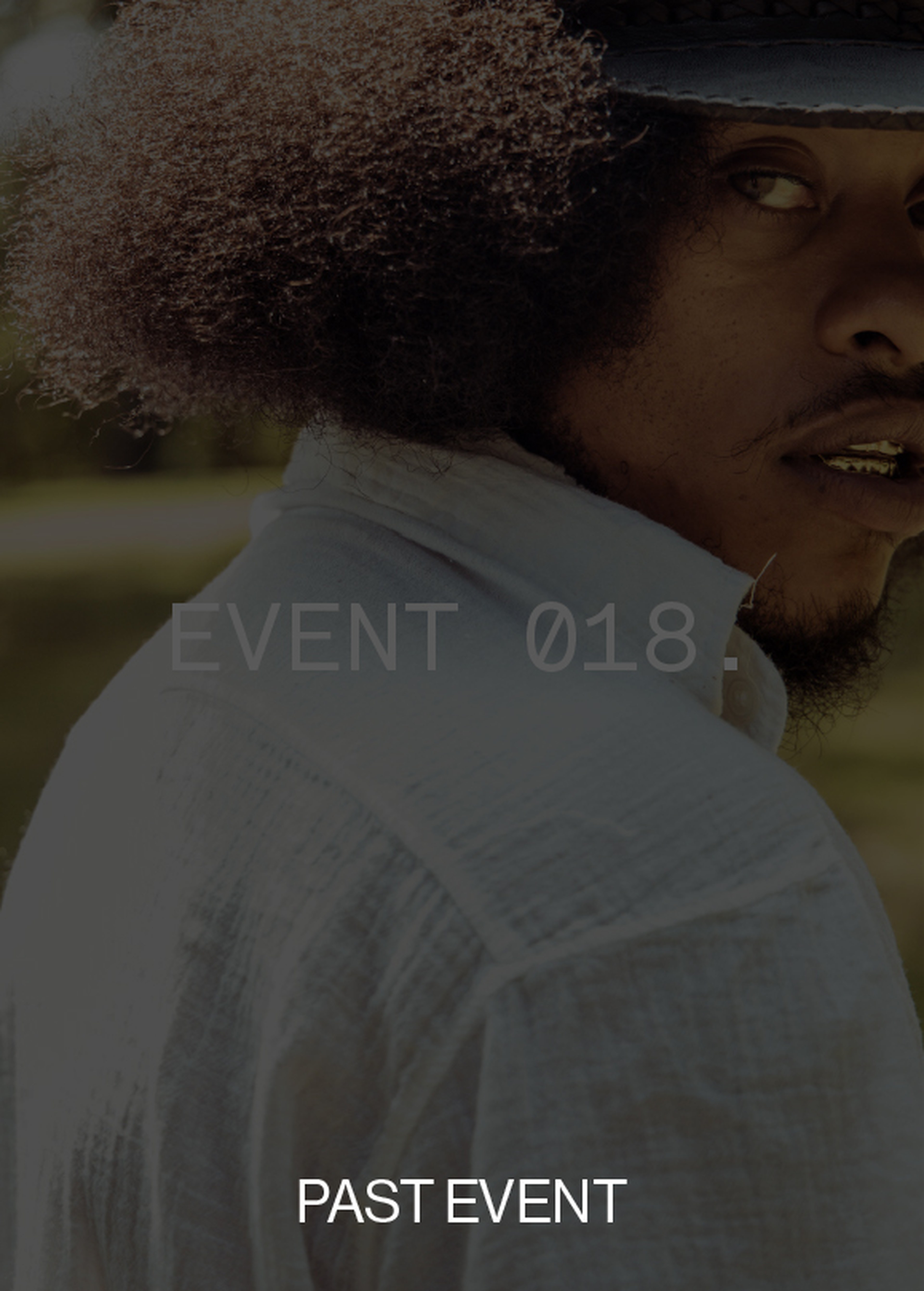 Person with curly hair wearing a hat and white shirt, looking over shoulder. Text overlaid: "EVENT 018." and "PAST EVENT."