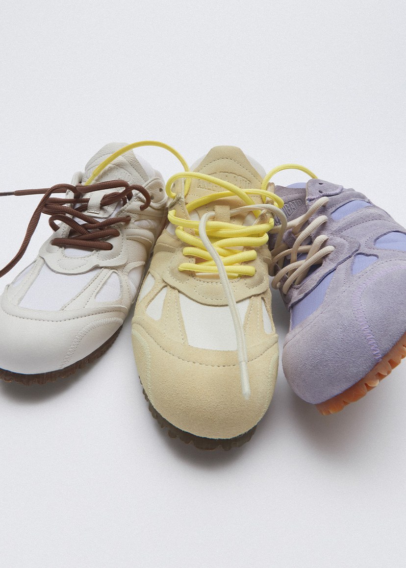 Three sneakers with different colors: brown and white, yellow and beige, purple with yellow. All feature unique lacing styles and textures.