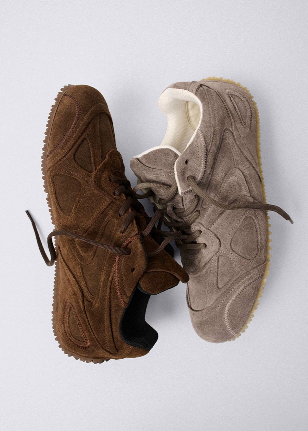 Two suede sneakers on a light background, one brown and one beige, each with unique textured patterns and thick rubber soles.