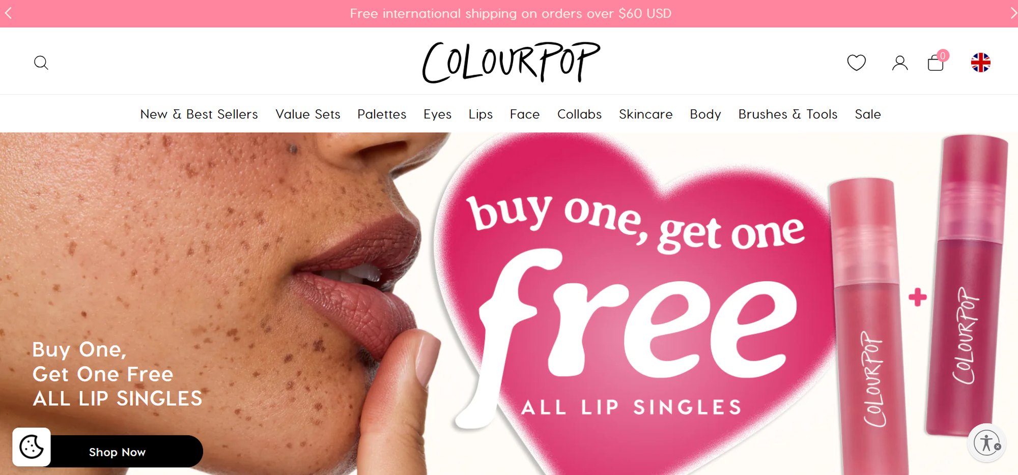 Close-up of a person with freckles next to a ColourPop promotion: "Buy one, get one free all lip singles" with two lip products displayed.