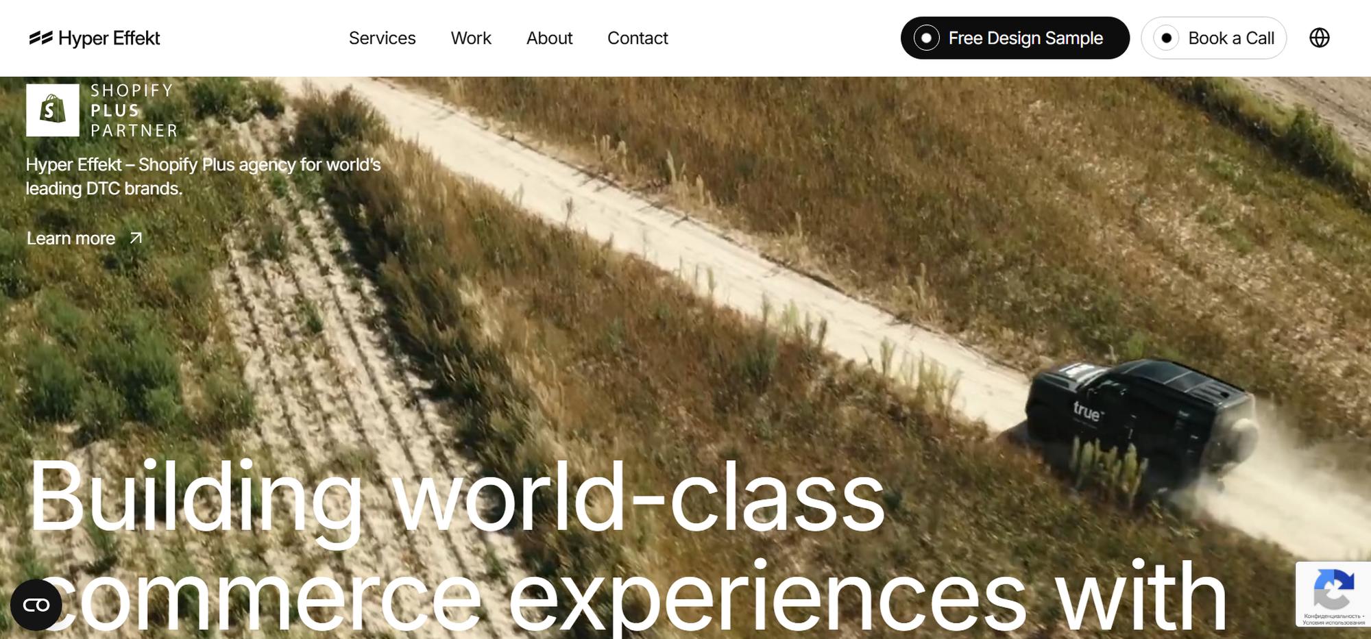 A green vehicle drives on a dirt road through a grassy field. Website header with navigation menu and text overlay.