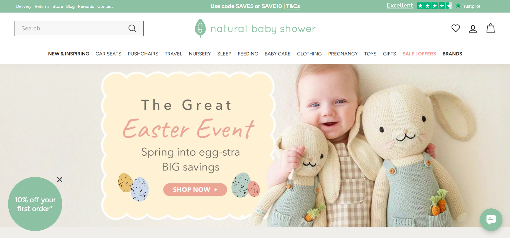 Smiling baby holding two plush bunnies next to a "The Great Easter Event" banner with savings details.