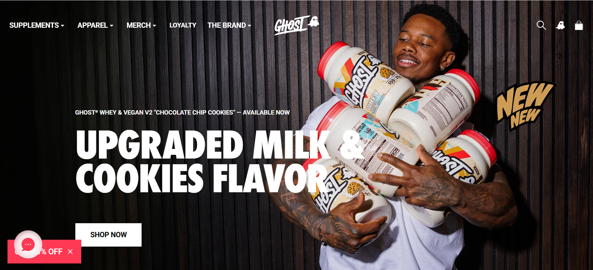 Man holding several protein containers in front of a dark wall. Text reads "Upgraded Milk & Cookies Flavor." Buttons for shopping options visible.