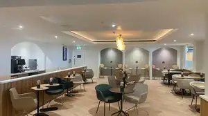 Escape Lounge with modern green and beige coloured chairs and wooden floors