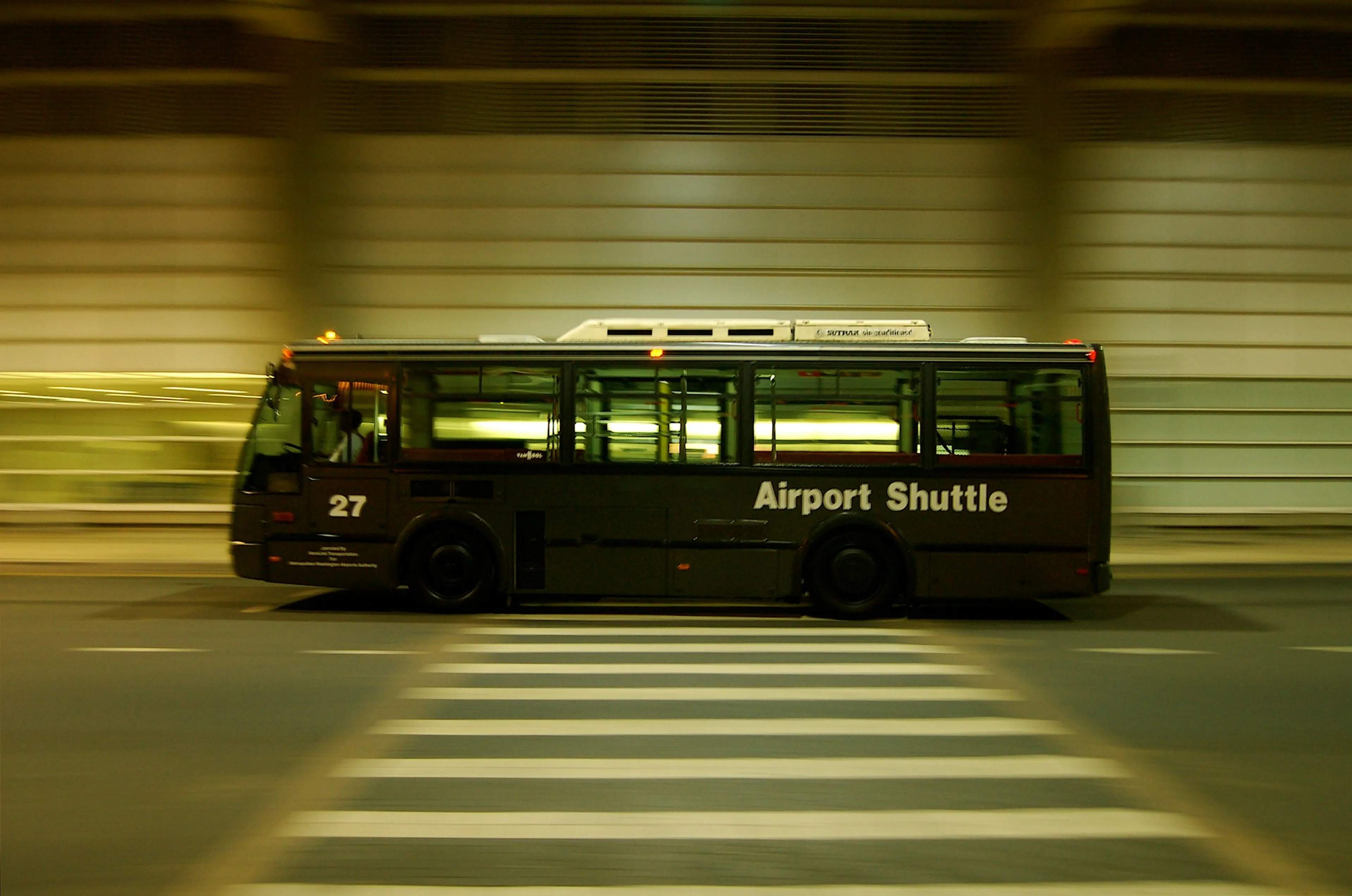 Airport shuttle bus driving at speed through a tunnel