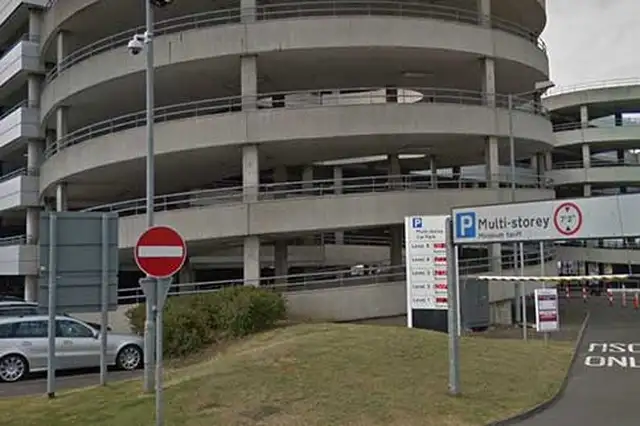 Entrance to Edinburgh Airport multi storey car park with ramp and signage