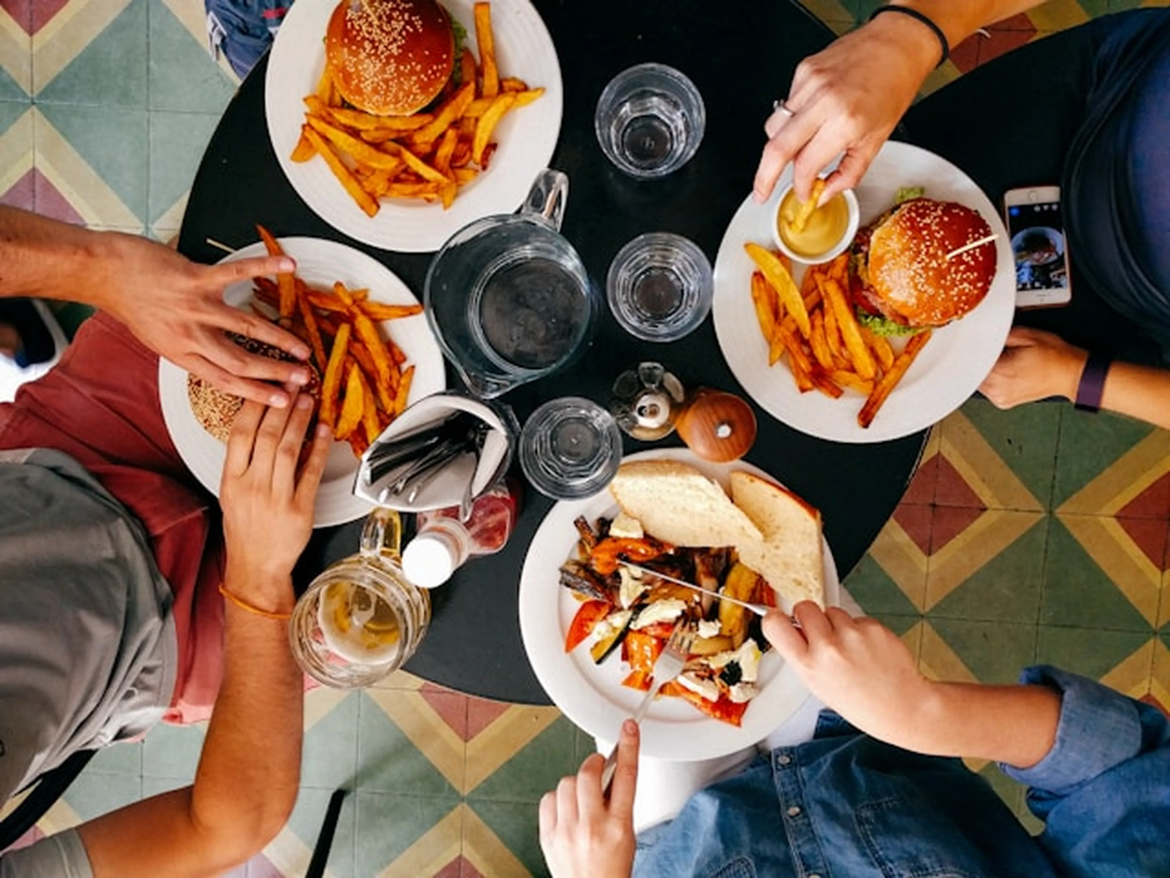 People eating dinner at a small table