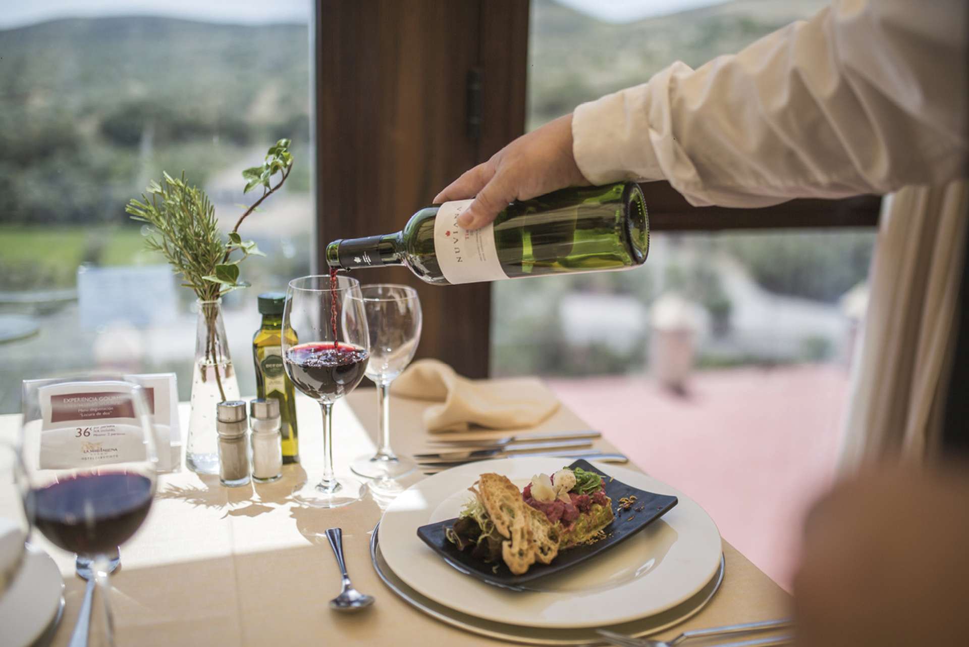 Waiter pouring wine in restaurant, Convento de la Magdalena, Spain