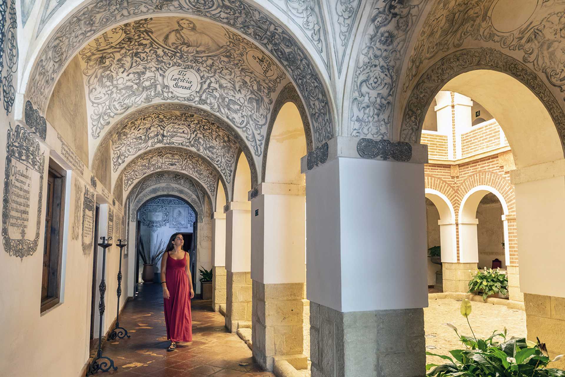 Woman walking through the hallway, Convento de la Magdalena, Spain