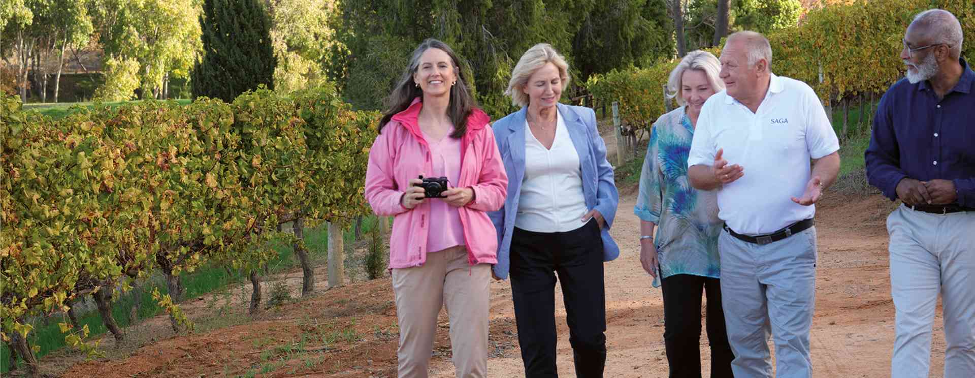 Group with tour manager in vineyard