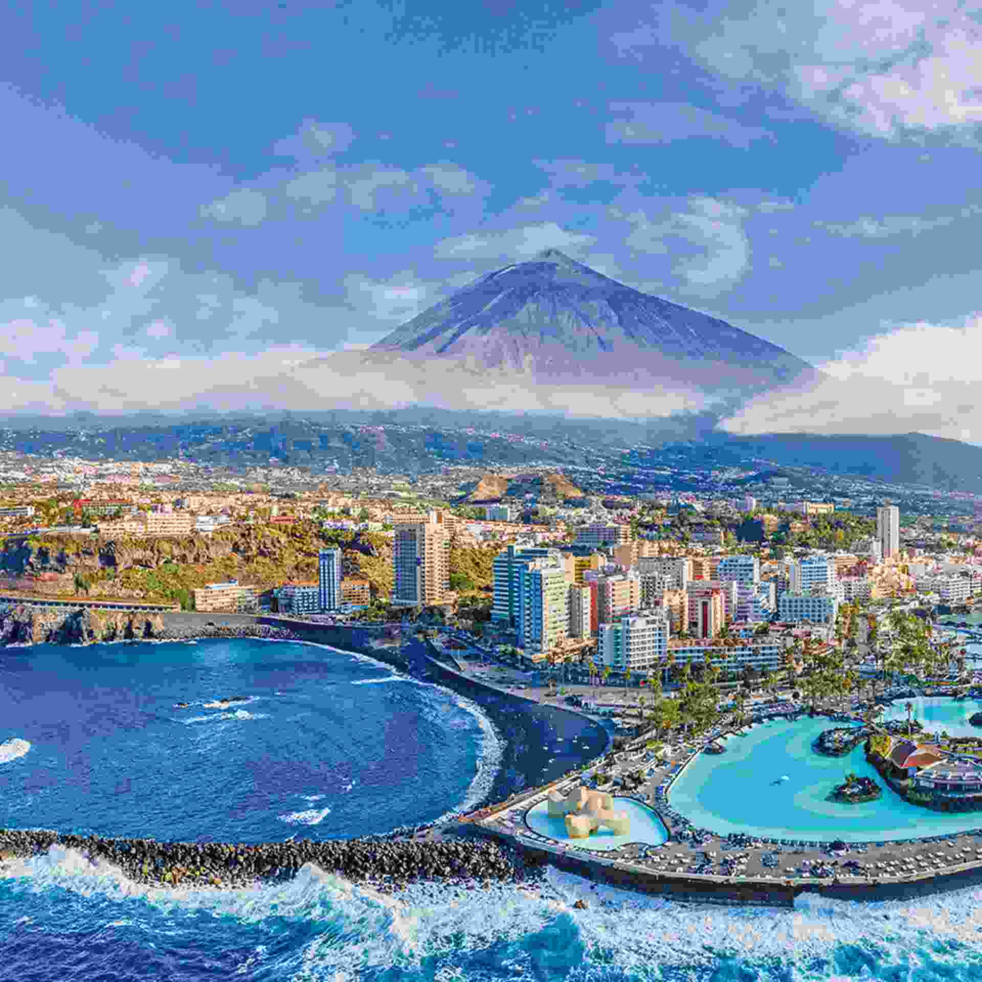 Aerial view of Puerto de la Cruz and Mount Teide volcano in background, Tenerife, Spain