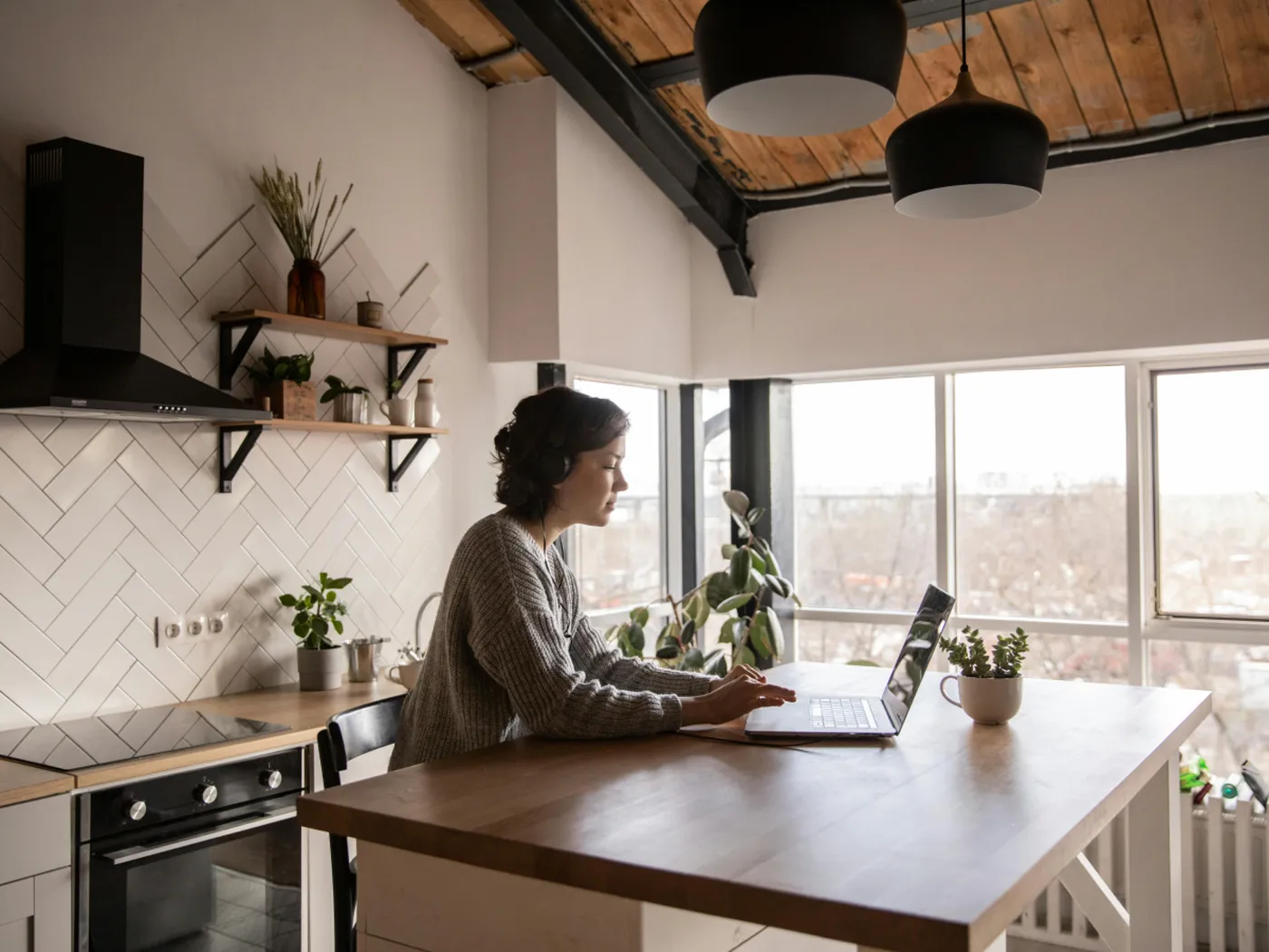 Woman looking at laptop in kitchen