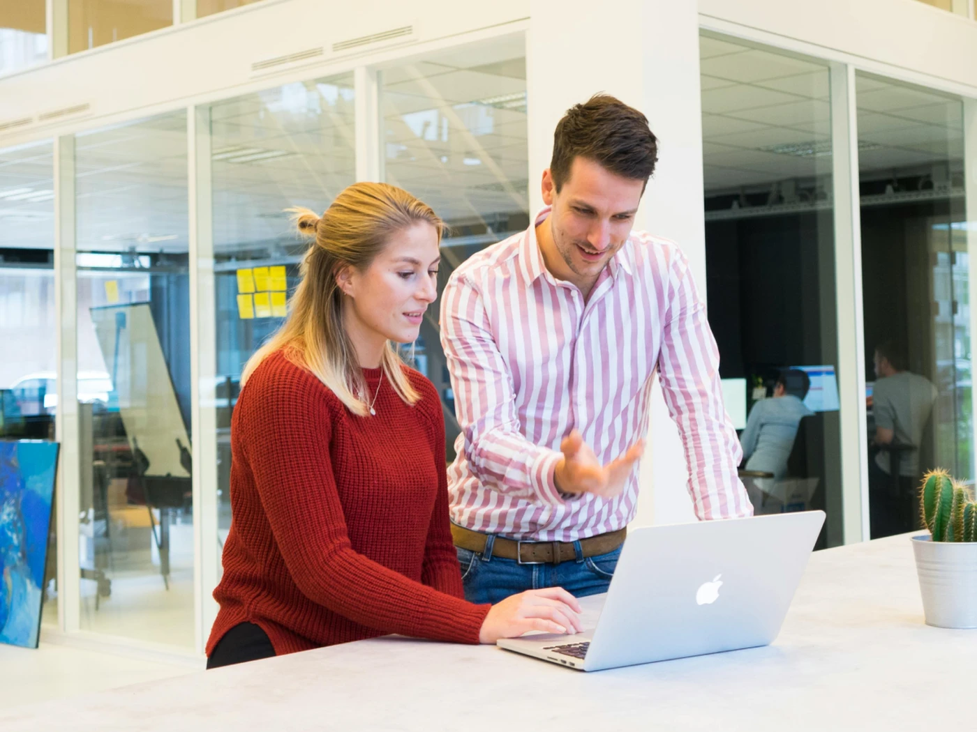 Two people meeting and having an explanation on a laptop