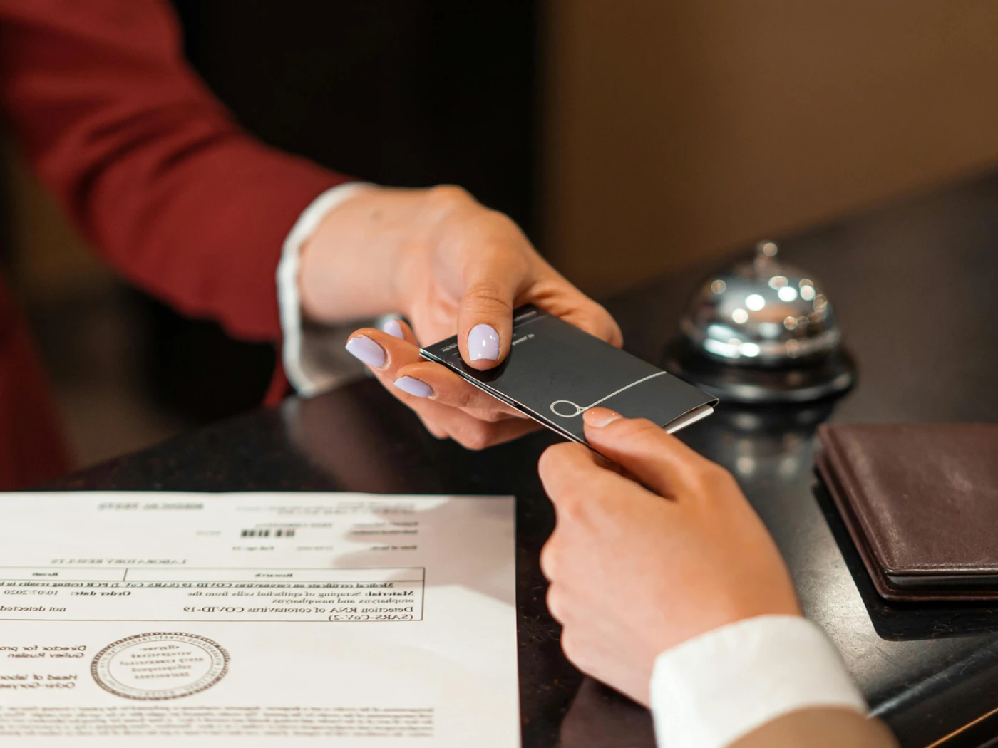 Keycard to a hotel room being handed over to the guest