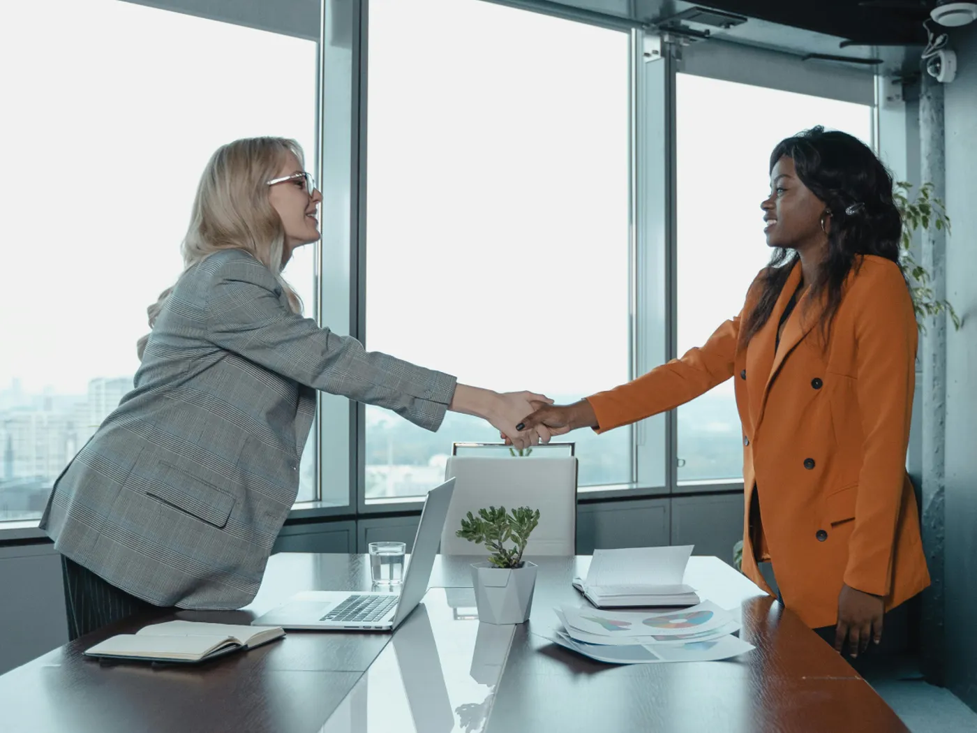 business partners shaking hands in an office