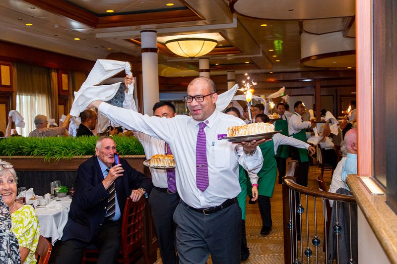 Baked Alaska parade in Buckingham Restaurant onboard Ambience Cruise Ship
