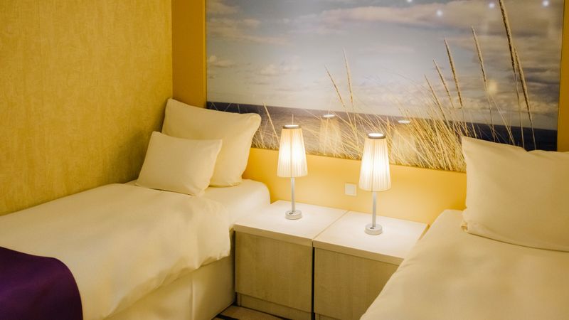 Single beds in an Ambassador Cruise Line inside cabin