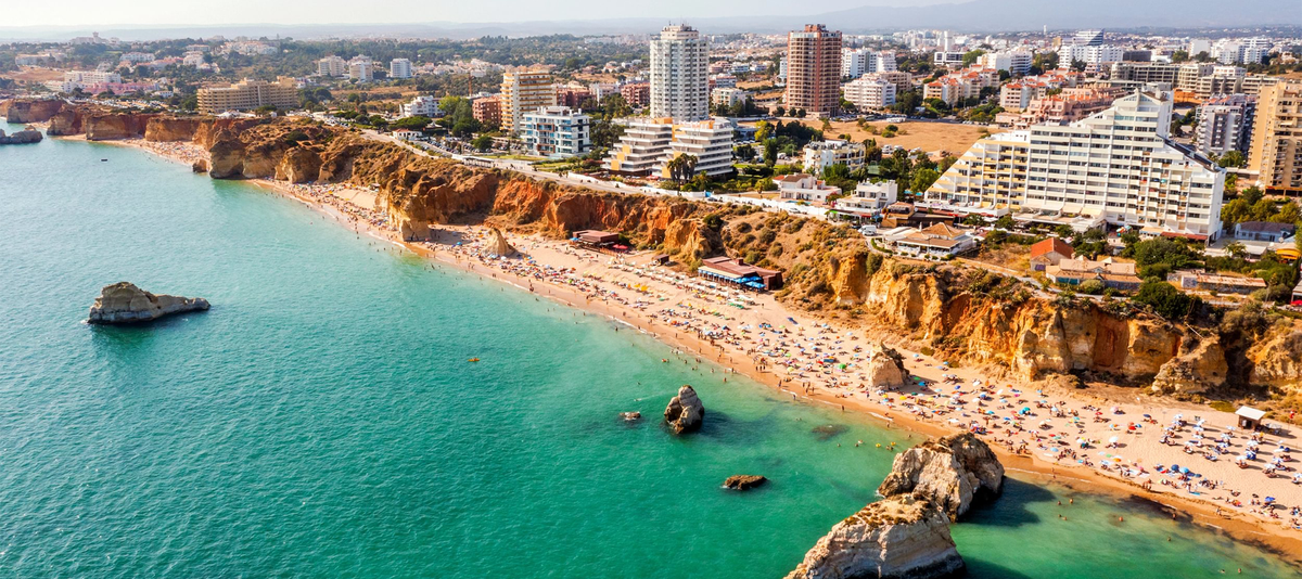 Aerial view of touristic Portimao with wide sandy Rocha beach, Algarve, Portugal