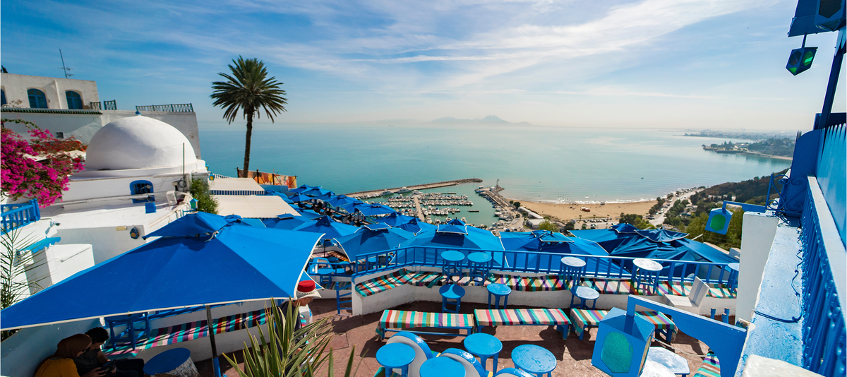 Panoramic view of seaside and cafe terrace in Sidi Bou Said at sunset. Tunisia, North Africa