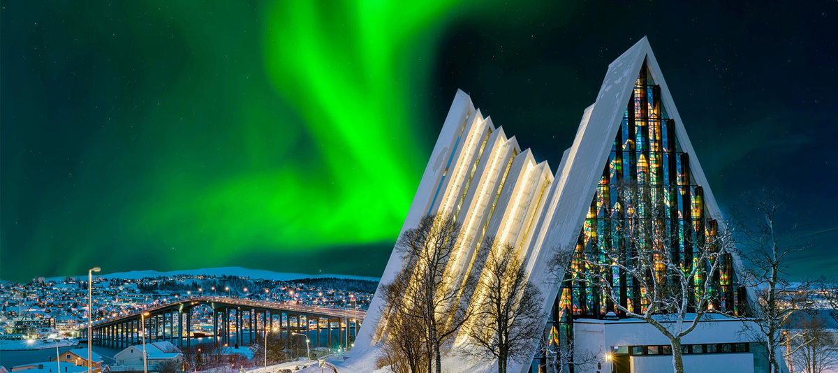 Stunning northern lights over the, snow-covered Eismeerkathedrale in Tromso, Norway