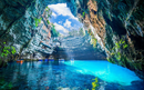 Melissani cave with a partially open roof, revealing clear skies, Kefalonia, Greece