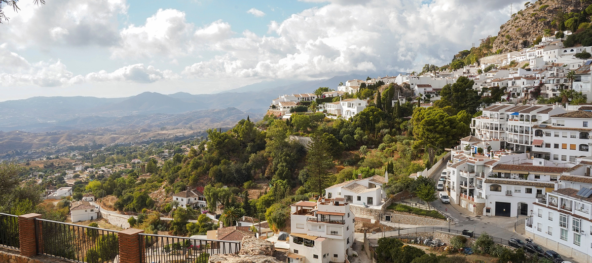 The spanish white washed village of Mijas pueblo with Sierra de Mijas behind, Andalusia, Malaga province, Spain