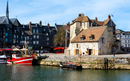 Harbor of Honfleur with the old pier, the Lieutenance house and 2 fishing boats, Normandy, France