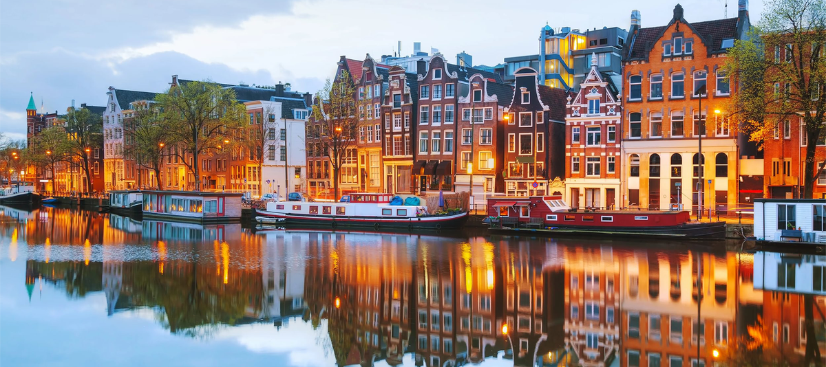Night city view of Amsterdam, the Netherlands with Amstel river