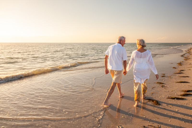 Couple holding hands on beach