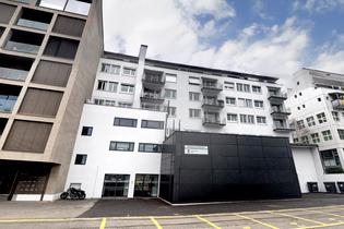 apartment buildings in zurich wollishofen usz against a blue sky