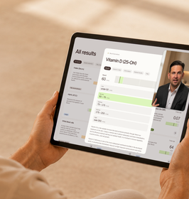 Person holding a tablet showing blood test results reviewed by a doctor