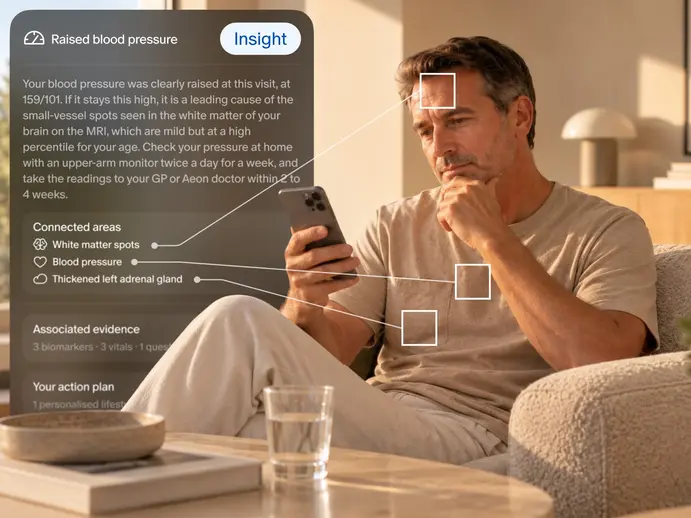 Raised blood pressure insight linking white matter spots, blood pressure and a thickened left adrenal gland, beside a man reading his phone