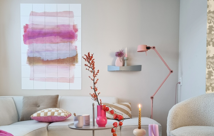 IXXI of a pink abstract design above a sofa in a light living room