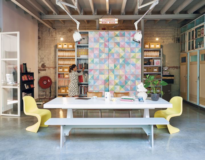 Large IXXI with a pastel triangle pattern covering a wall of shelving in a studio