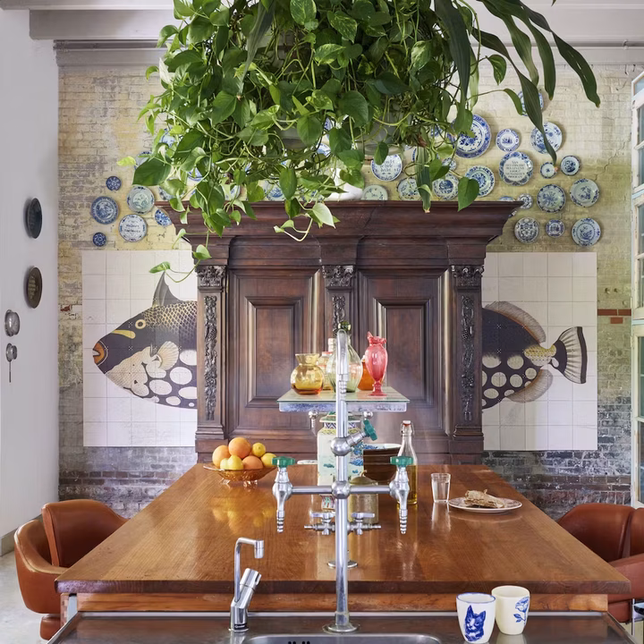 One fish design split in two, hung either side of a wooden cabinet in a dining room