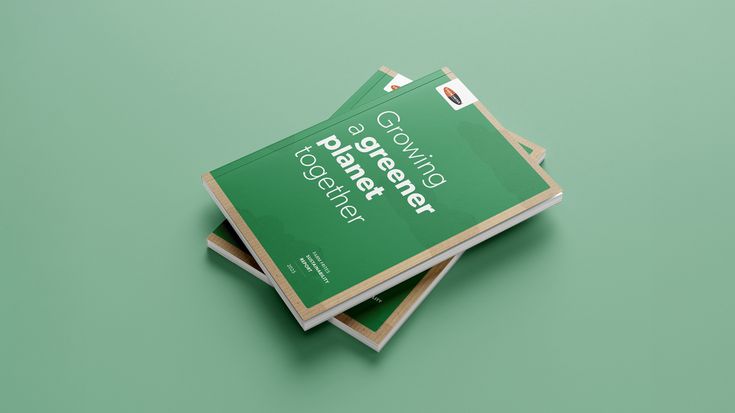 Stack of green booklets titled "Growing a greener planet together" on a matching green background.