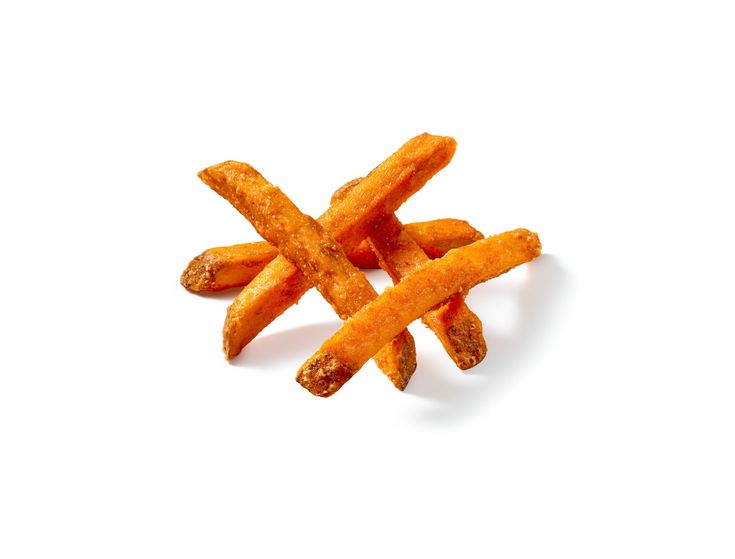 A pile of crispy, golden-brown sweet potato fries stacked against a white background.