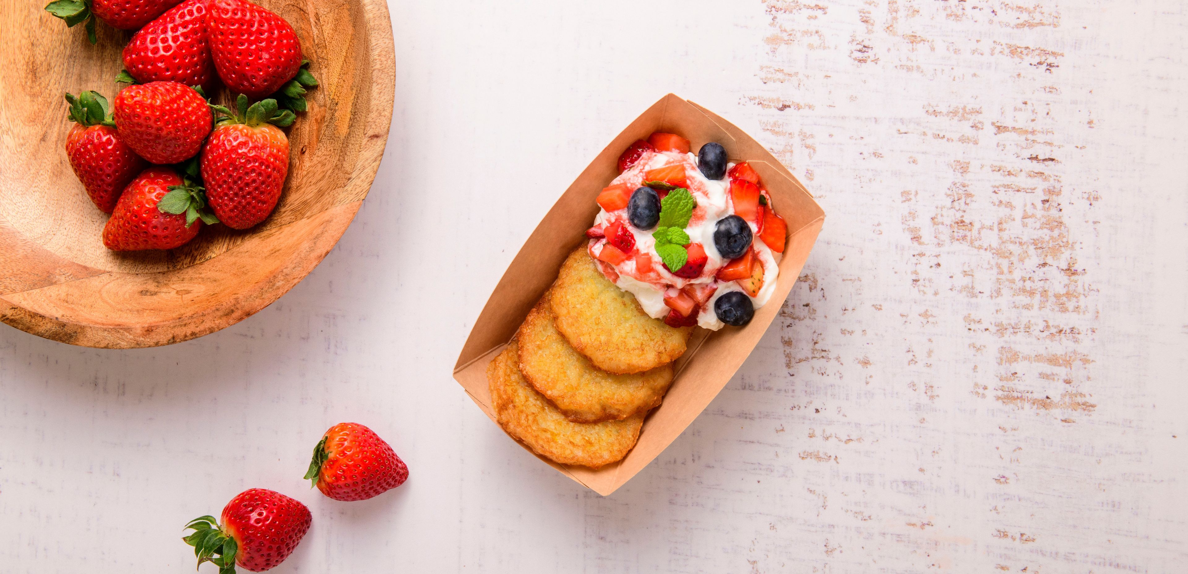 mini potato pancakes with whipped cream and berries