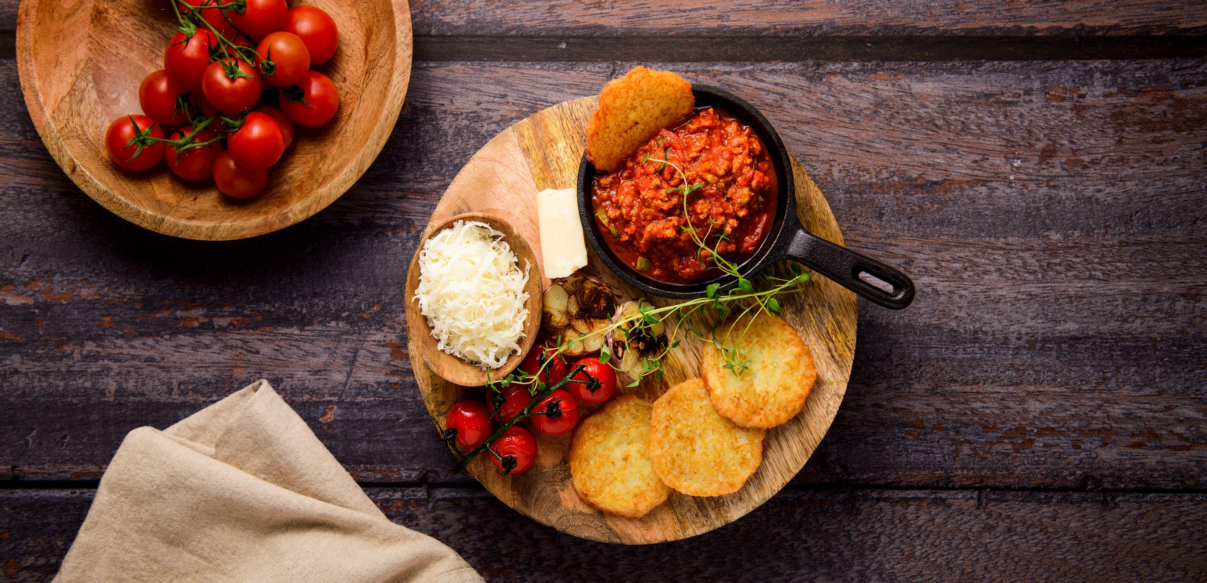 mini potato pancakes with bolognese sauce and parmesan